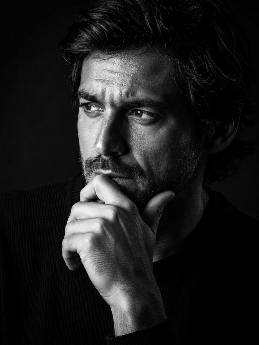 Black and white portrait prompt result with strong side light and film grain